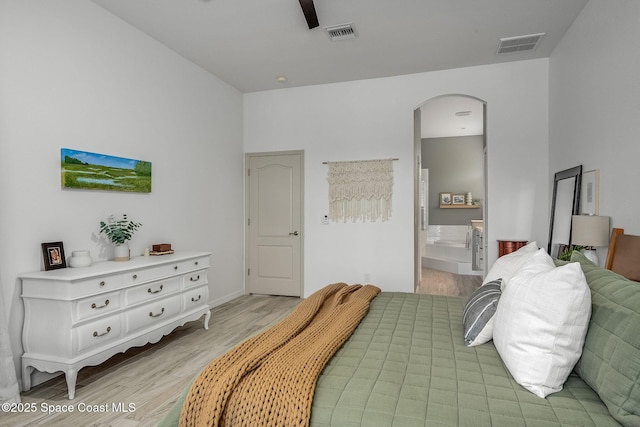 bedroom with ensuite bathroom and light hardwood / wood-style flooring