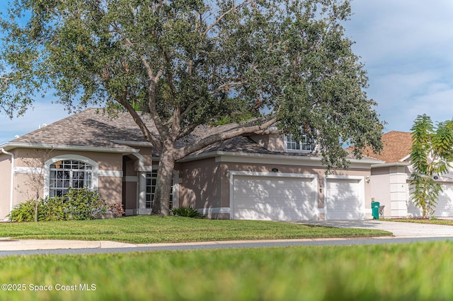 view of front of house featuring a garage and a front lawn