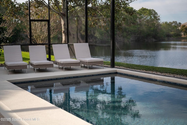 view of pool with a patio and a water view