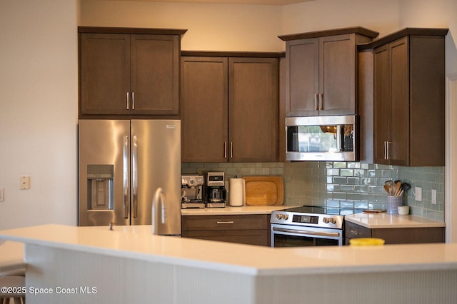 kitchen with appliances with stainless steel finishes, dark brown cabinets, and decorative backsplash