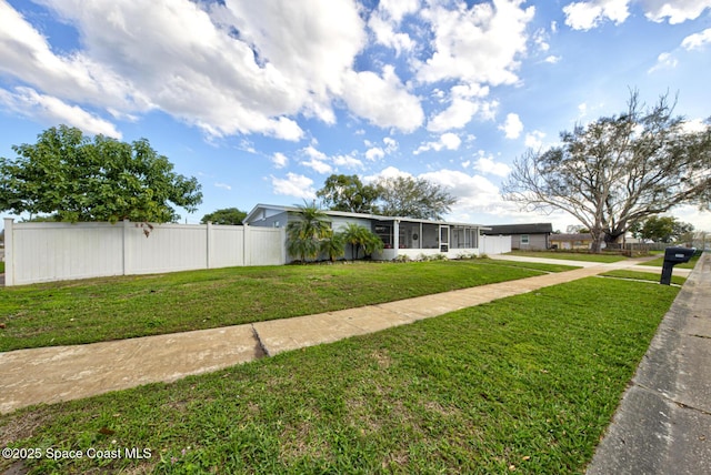 view of front facade featuring a front yard and a carport