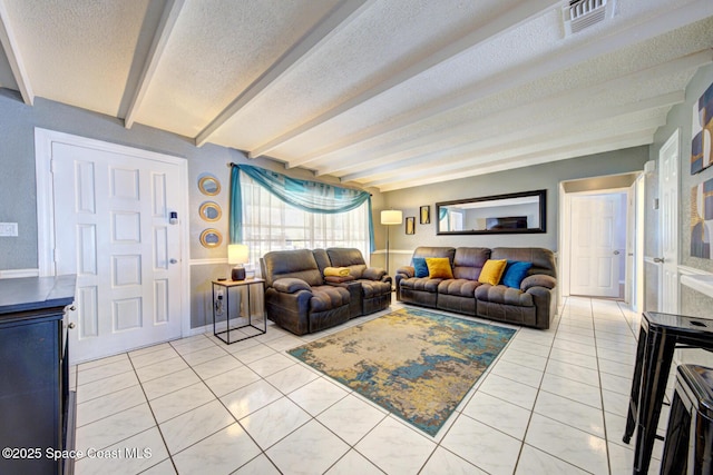 tiled living room with a textured ceiling and beam ceiling