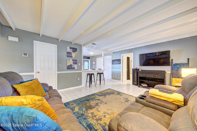 tiled living room featuring beamed ceiling and a textured ceiling