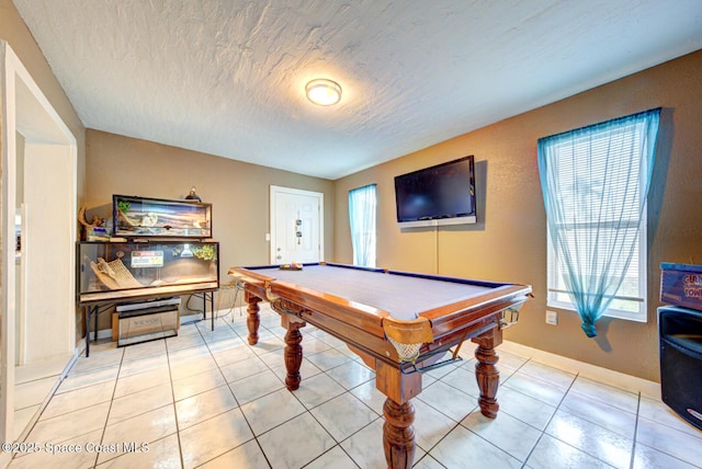 recreation room with light tile patterned floors, a textured ceiling, and pool table