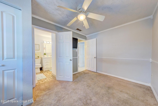 unfurnished bedroom with crown molding, ensuite bath, and light carpet