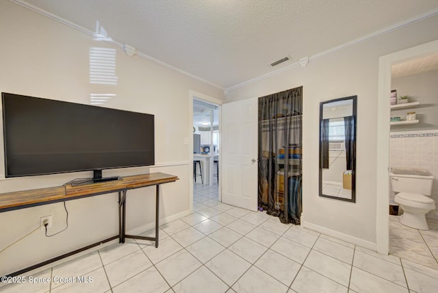 tiled living room with ornamental molding and a textured ceiling