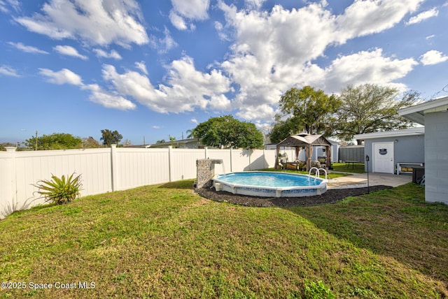 view of yard featuring a gazebo and a fenced in pool