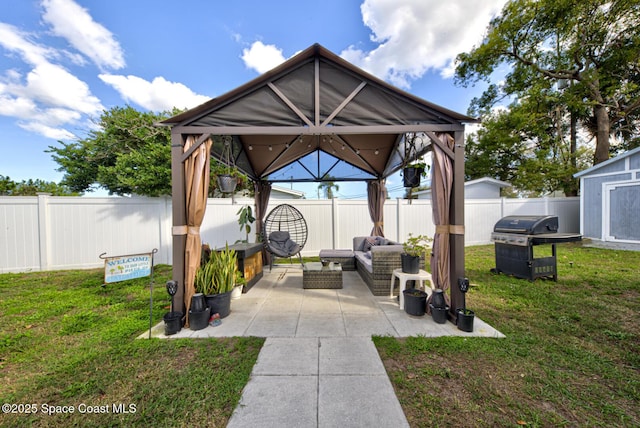 view of patio / terrace featuring a gazebo, outdoor lounge area, grilling area, and a storage shed