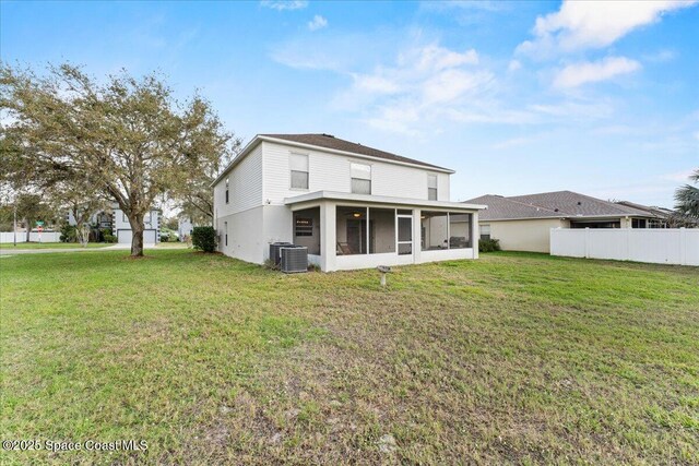 back of house featuring a yard, a sunroom, fence, and central AC unit