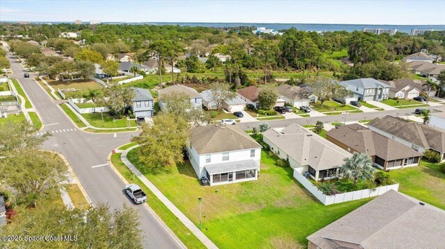 birds eye view of property featuring a residential view and a water view