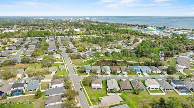 drone / aerial view featuring a water view and a residential view