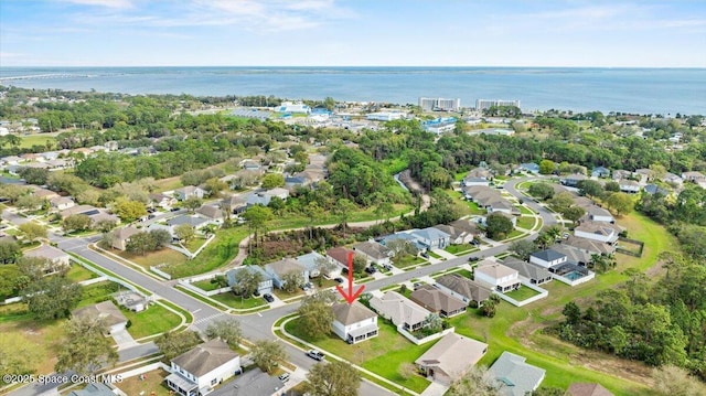 drone / aerial view with a water view and a residential view