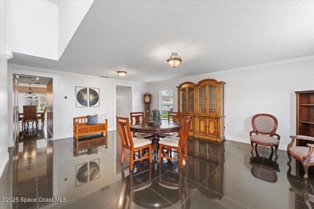 dining area featuring crown molding, a textured ceiling, and baseboards