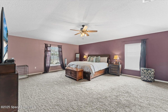 bedroom featuring a textured ceiling, carpet, a ceiling fan, and baseboards