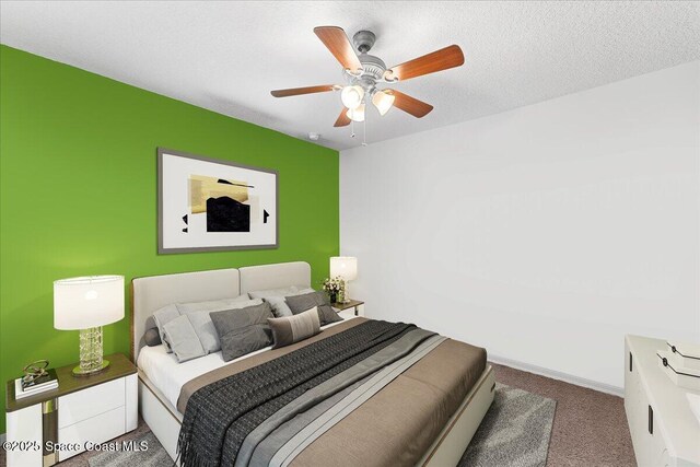 carpeted bedroom with baseboards, a ceiling fan, and a textured ceiling