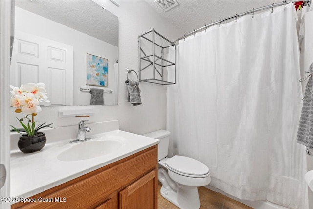 full bathroom featuring visible vents, toilet, a textured ceiling, vanity, and tile patterned floors