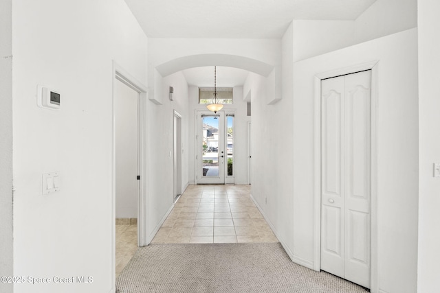 hall with light tile patterned flooring