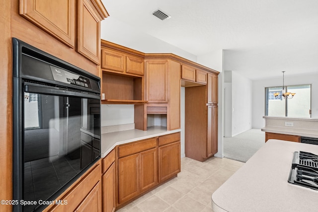 kitchen featuring an inviting chandelier, hanging light fixtures, gas stovetop, light tile patterned flooring, and oven