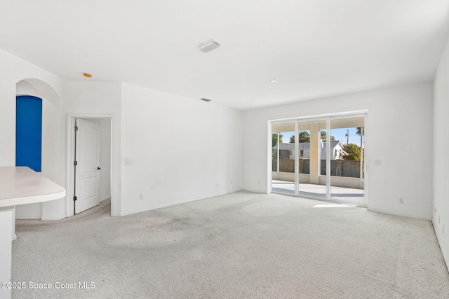 unfurnished room featuring light carpet