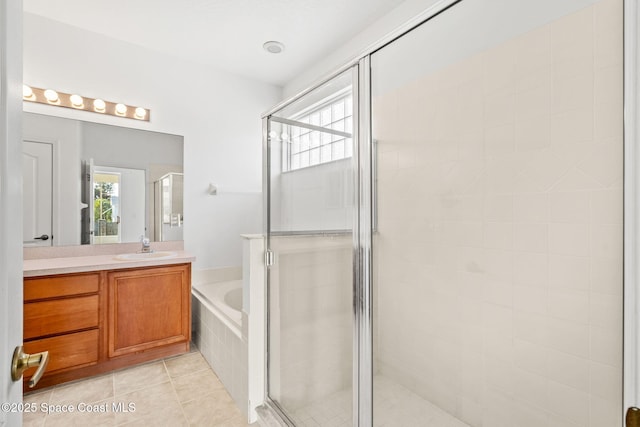 bathroom featuring independent shower and bath, vanity, and tile patterned floors