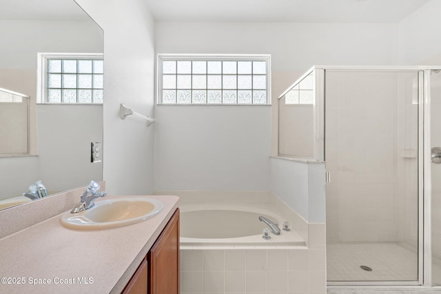 bathroom featuring vanity and separate shower and tub