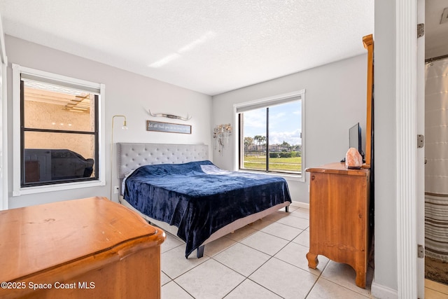 tiled bedroom with a textured ceiling