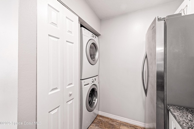 laundry room featuring stacked washer / dryer