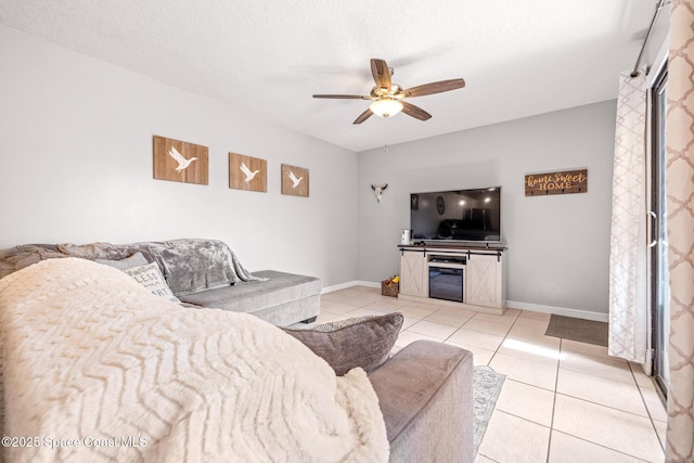 tiled living room with a textured ceiling and ceiling fan