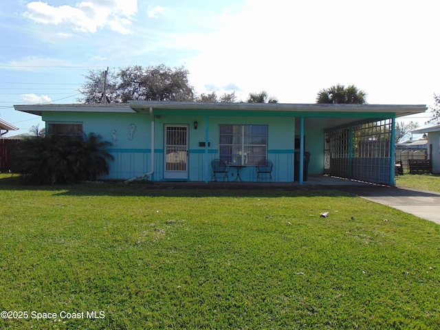 ranch-style home with a carport and a front yard