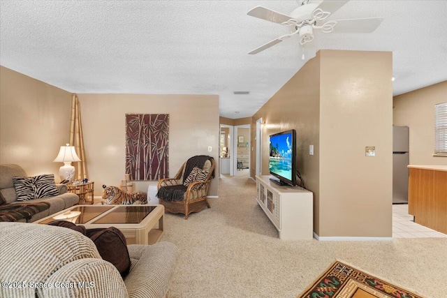 carpeted living room with ceiling fan and a textured ceiling