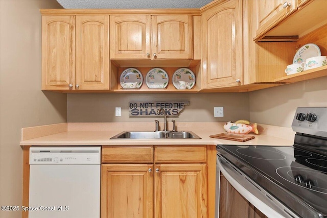 kitchen featuring dishwasher, sink, light brown cabinets, and stainless steel electric range