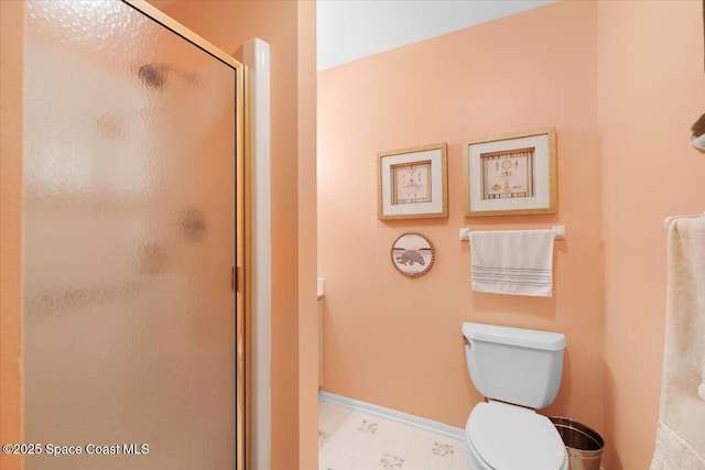 bathroom with toilet and an enclosed shower