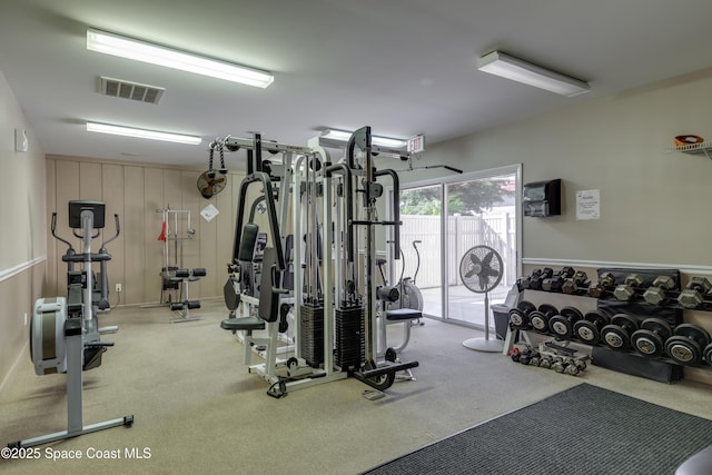 workout area featuring light carpet