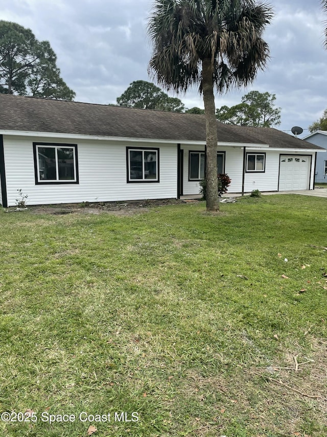 ranch-style home with a garage and a front lawn