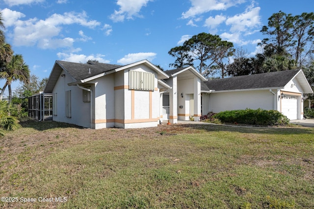 view of front of property with a garage and a front yard