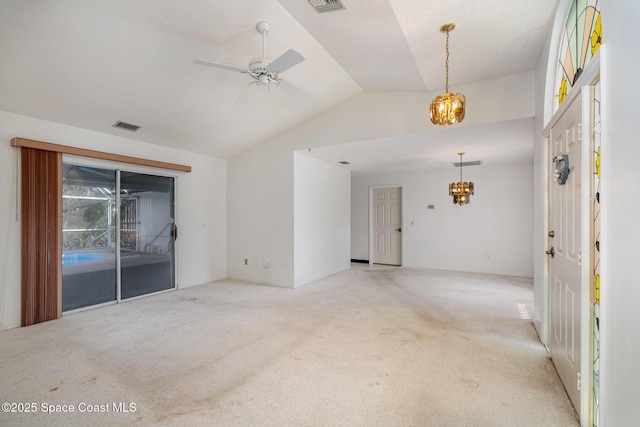 empty room with vaulted ceiling, light colored carpet, and ceiling fan