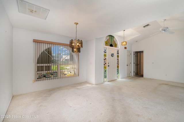 carpeted spare room with lofted ceiling and ceiling fan with notable chandelier