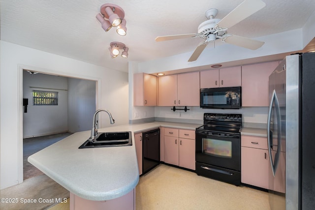 kitchen with kitchen peninsula, sink, a textured ceiling, and black appliances