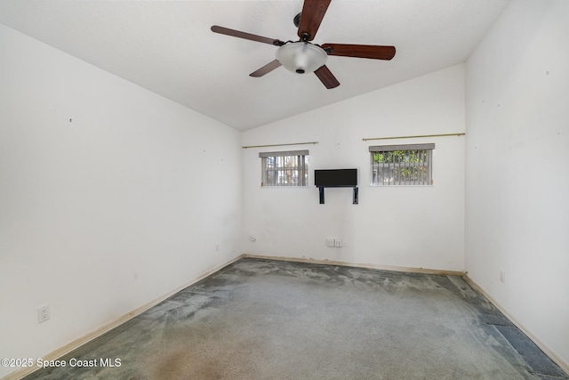 carpeted spare room with lofted ceiling and ceiling fan