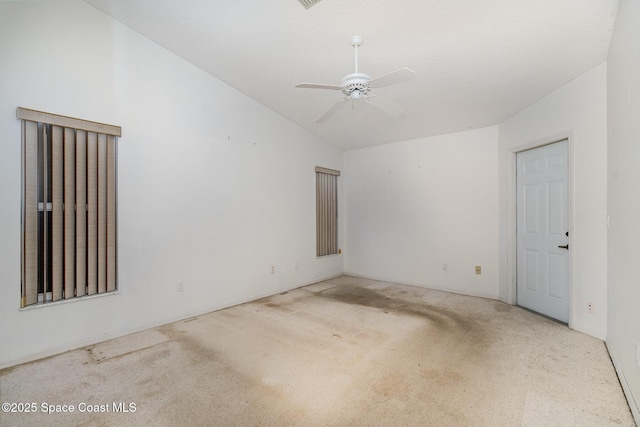 carpeted empty room featuring ceiling fan