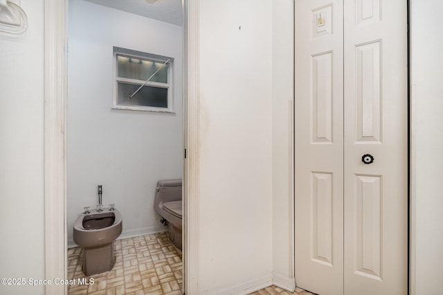 bathroom featuring a bidet and toilet