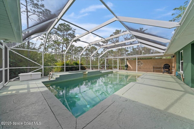 view of swimming pool with a patio and glass enclosure