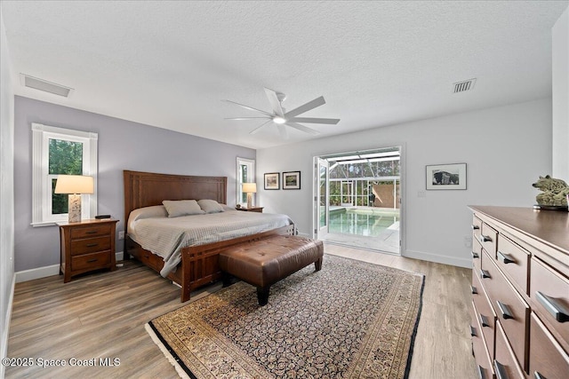 bedroom featuring access to exterior, ceiling fan, a textured ceiling, and light wood-type flooring