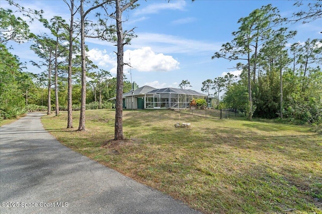 view of yard featuring glass enclosure