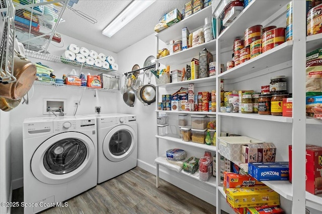 laundry area featuring washer and clothes dryer, hardwood / wood-style floors, and a textured ceiling