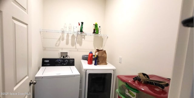 laundry room with washing machine and clothes dryer