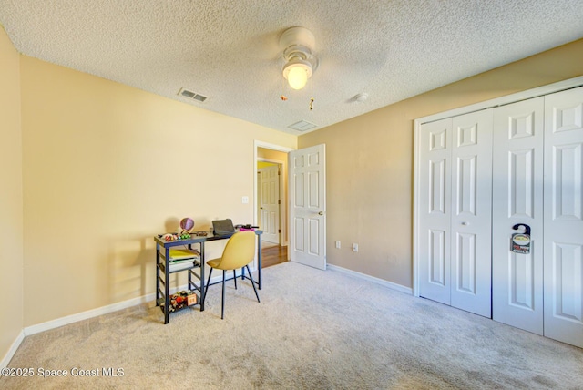 office with ceiling fan, light colored carpet, and a textured ceiling