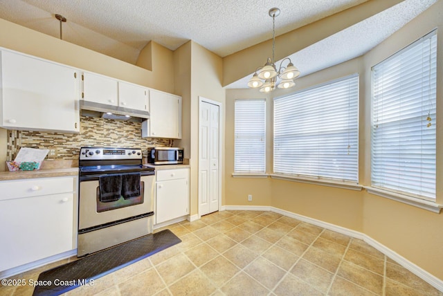 kitchen featuring appliances with stainless steel finishes, pendant lighting, tasteful backsplash, white cabinets, and light tile patterned floors