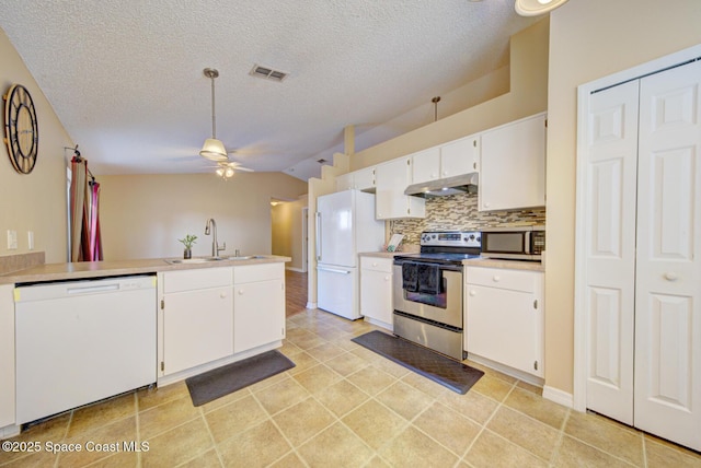 kitchen with sink, tasteful backsplash, appliances with stainless steel finishes, ceiling fan, and white cabinets