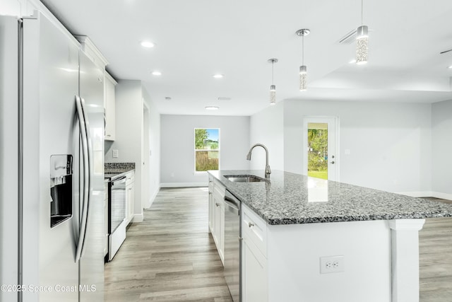 kitchen with white cabinetry, appliances with stainless steel finishes, sink, and hanging light fixtures